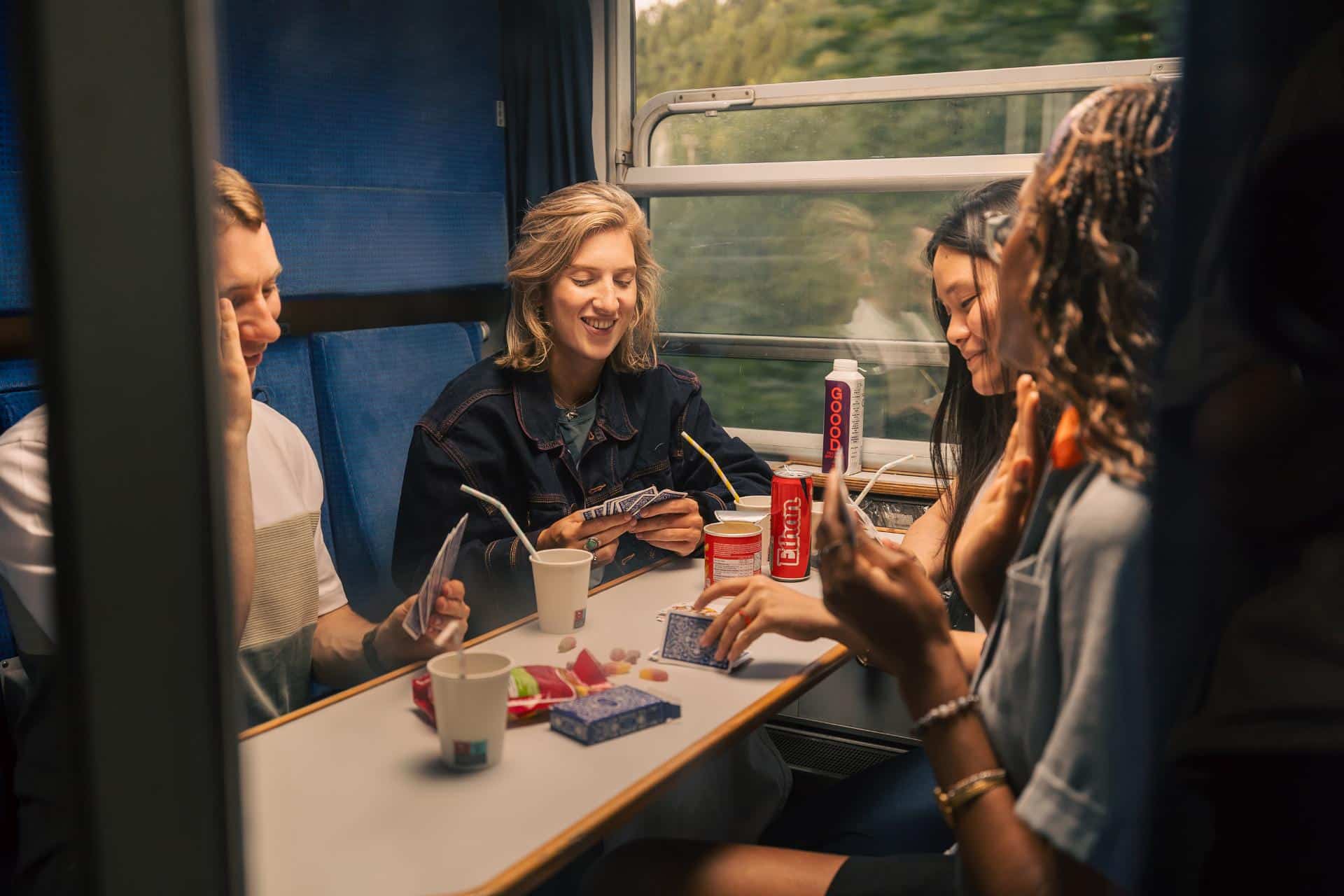 Group of friends playing cards on the European Sleeper train.